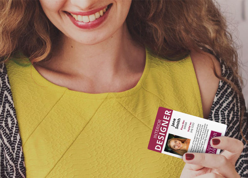 Online interior design course student holding an ID